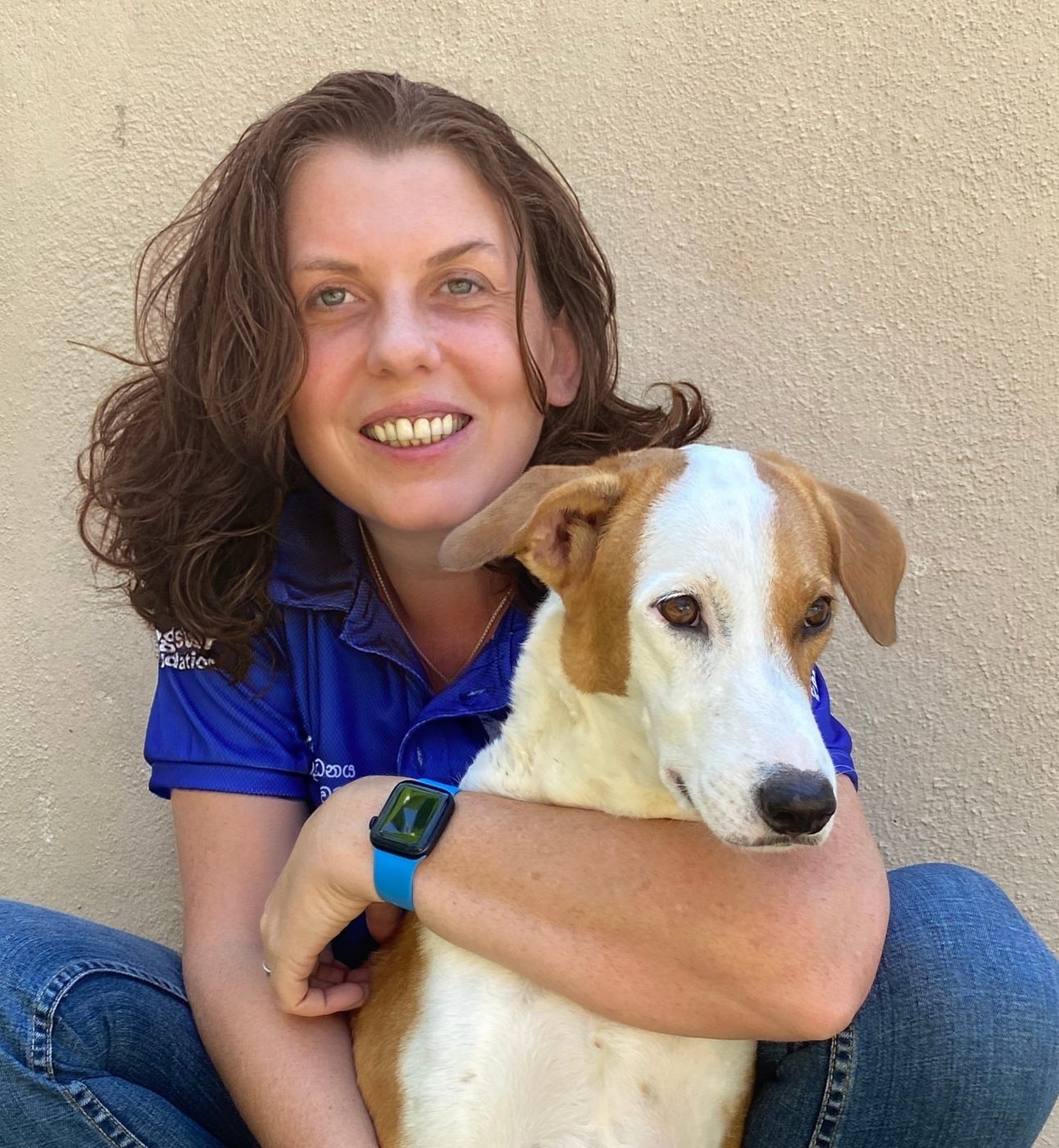 Portrait of Dogstar's CEO Sam hugging her rescue dog Star.